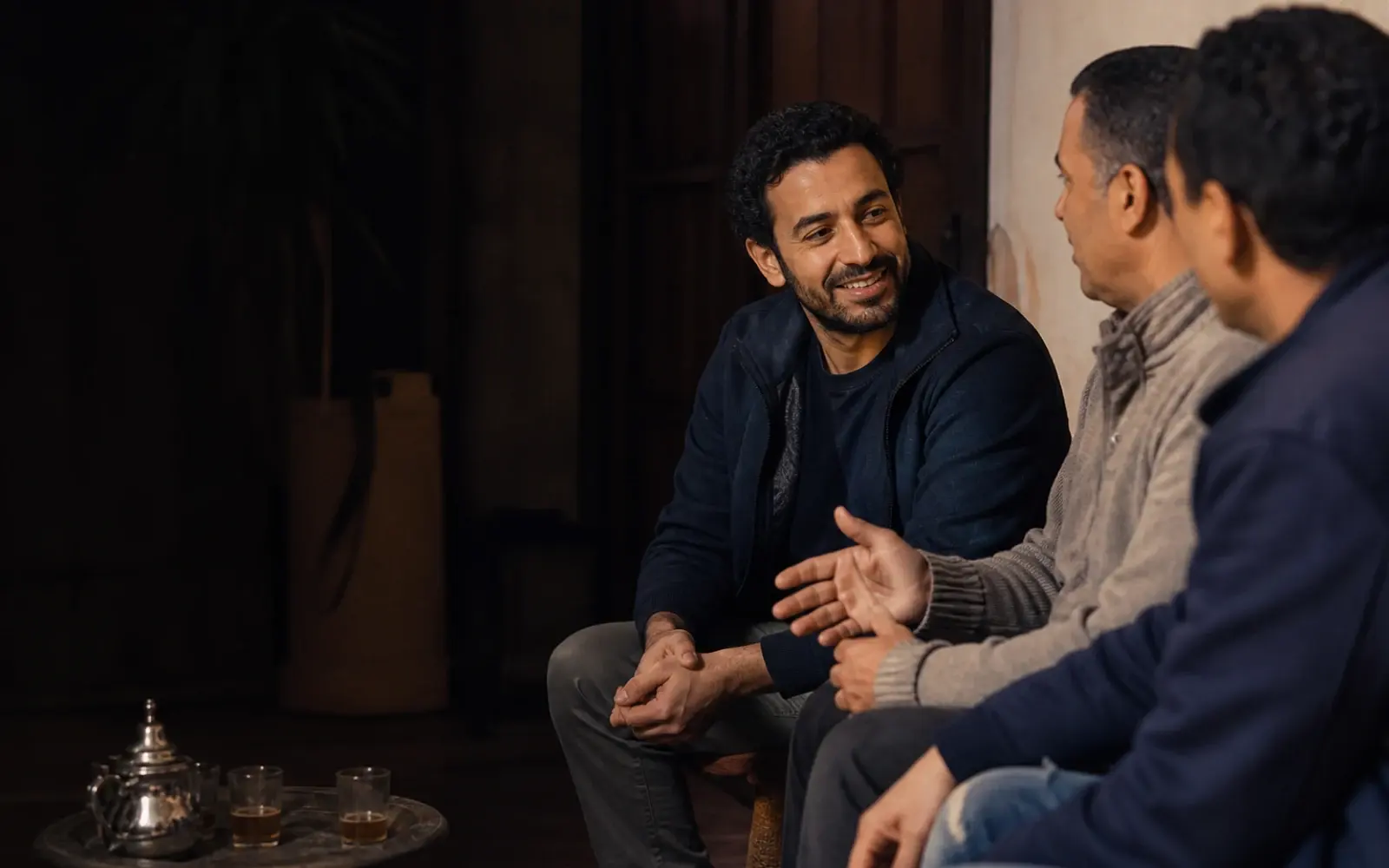 Community members in conversation over tea